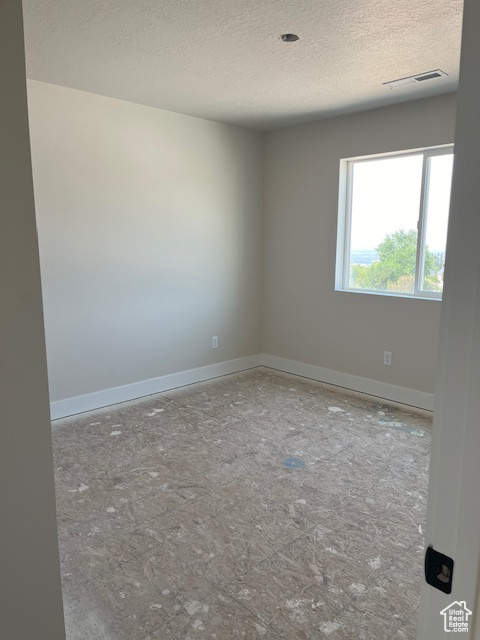 Spare room with a textured ceiling