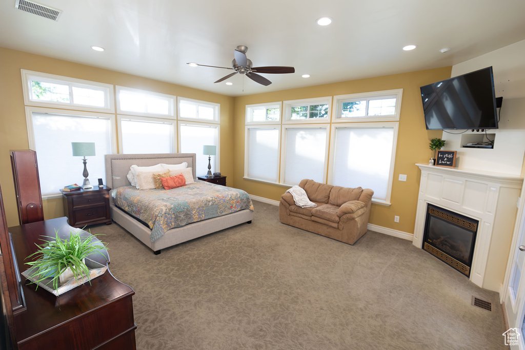 Carpeted bedroom featuring ceiling fan