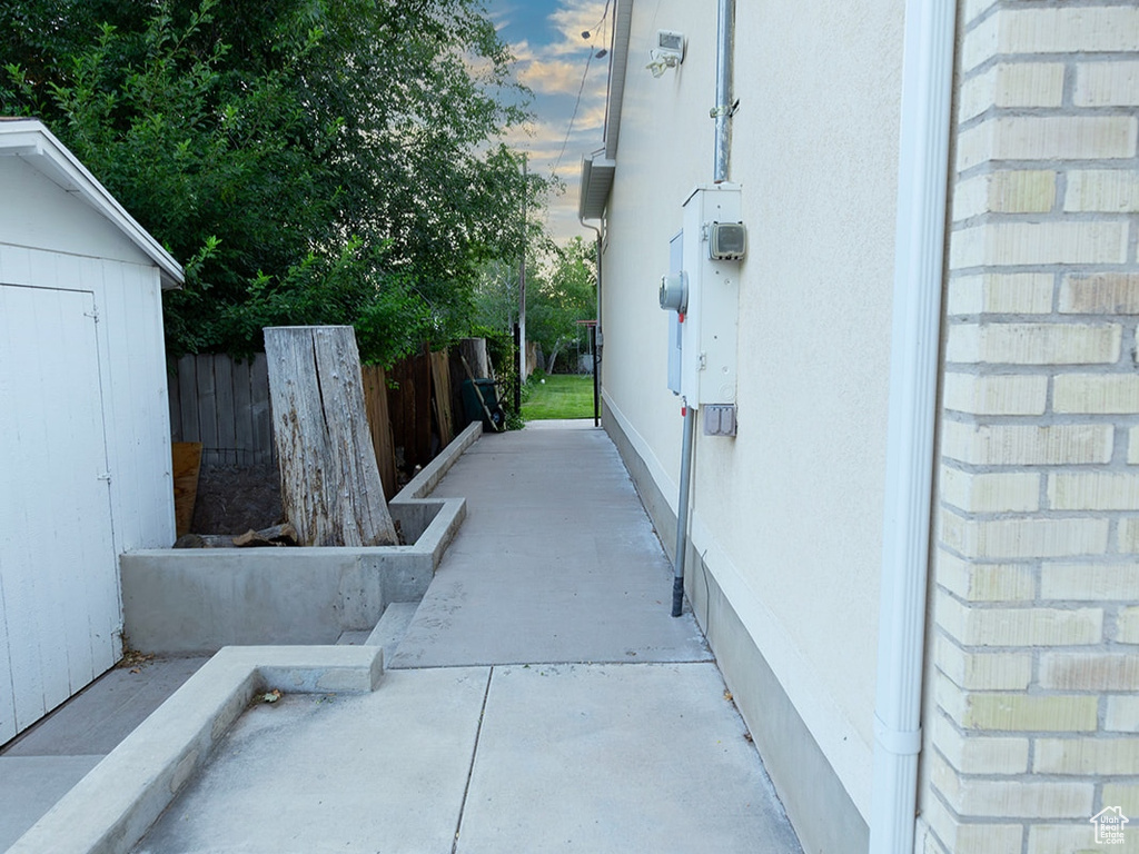 View of patio with a shed