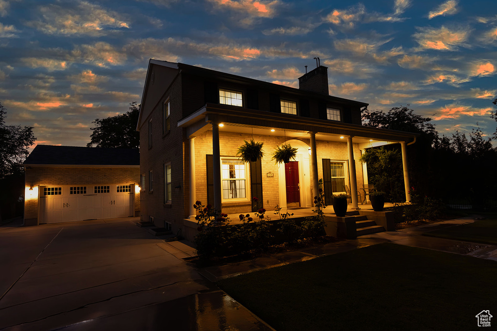 View of front facade with a porch and a garage