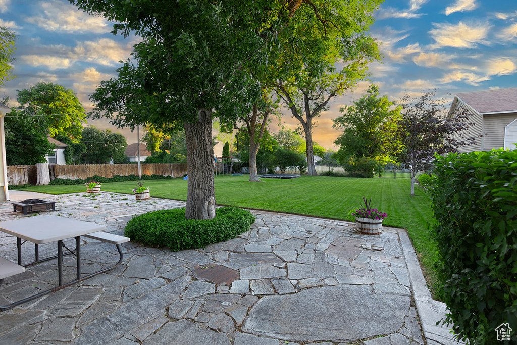 Patio terrace at dusk with a yard