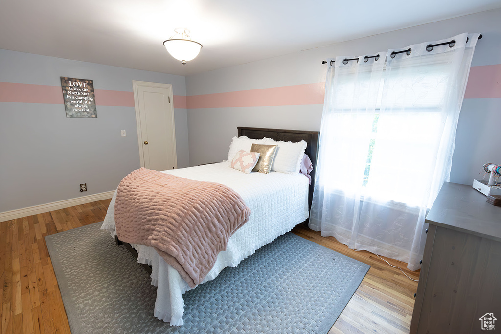 Bedroom with hardwood / wood-style floors