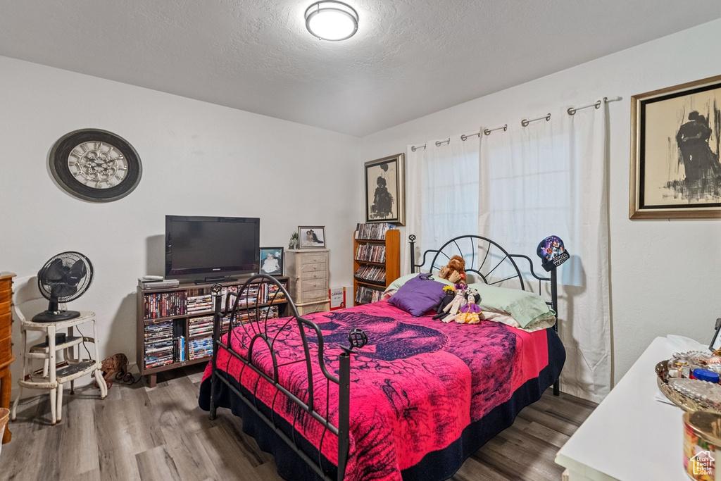 Bedroom featuring wood-type flooring