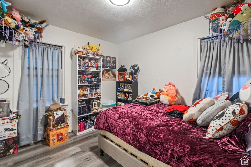 Bedroom featuring a textured ceiling and hardwood / wood-style flooring