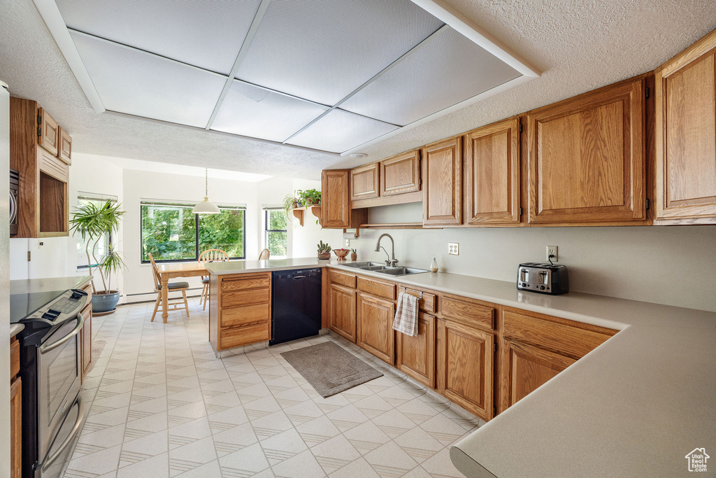 Kitchen featuring light tile patterned floors, kitchen peninsula, stainless steel range with electric stovetop, dishwasher, and sink