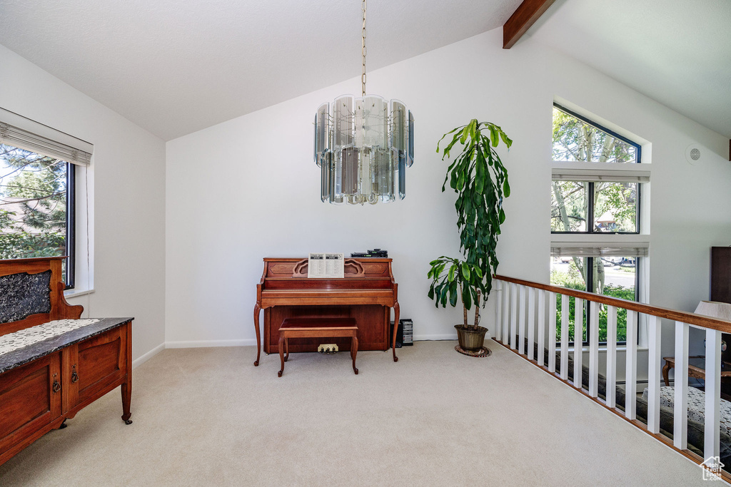 Sitting room featuring lofted ceiling with beams, a chandelier, and light carpet