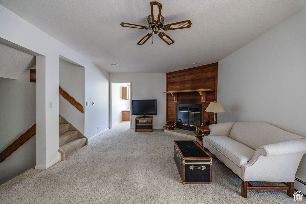 Carpeted living room featuring ceiling fan