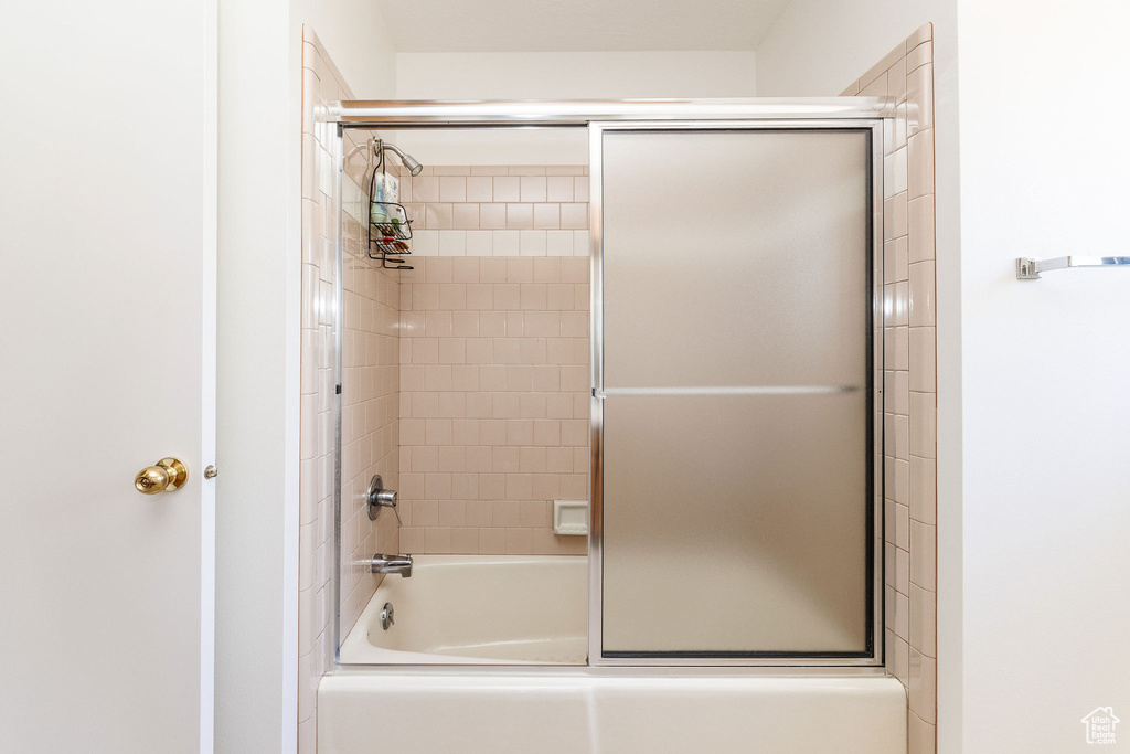 Bathroom with enclosed tub / shower combo