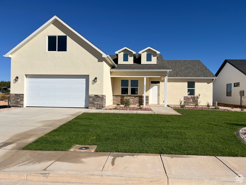 View of front of property with a front lawn and covered porch