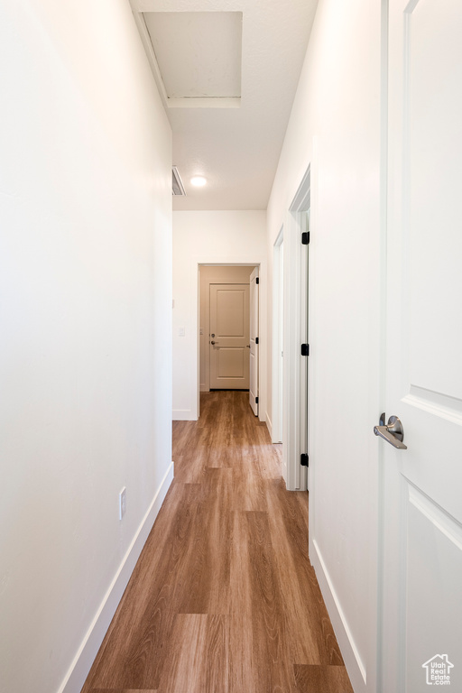 Corridor featuring light wood-type flooring