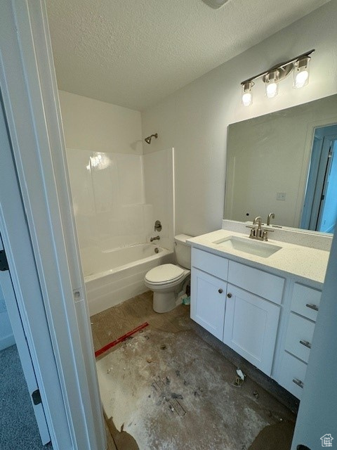 Full bathroom featuring shower / bathtub combination, vanity, a textured ceiling, and toilet