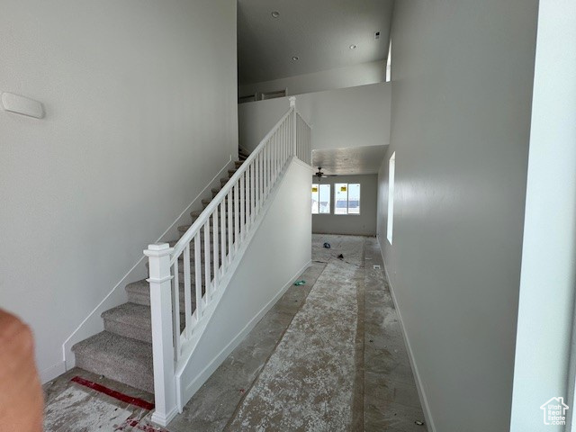 Staircase featuring a high ceiling