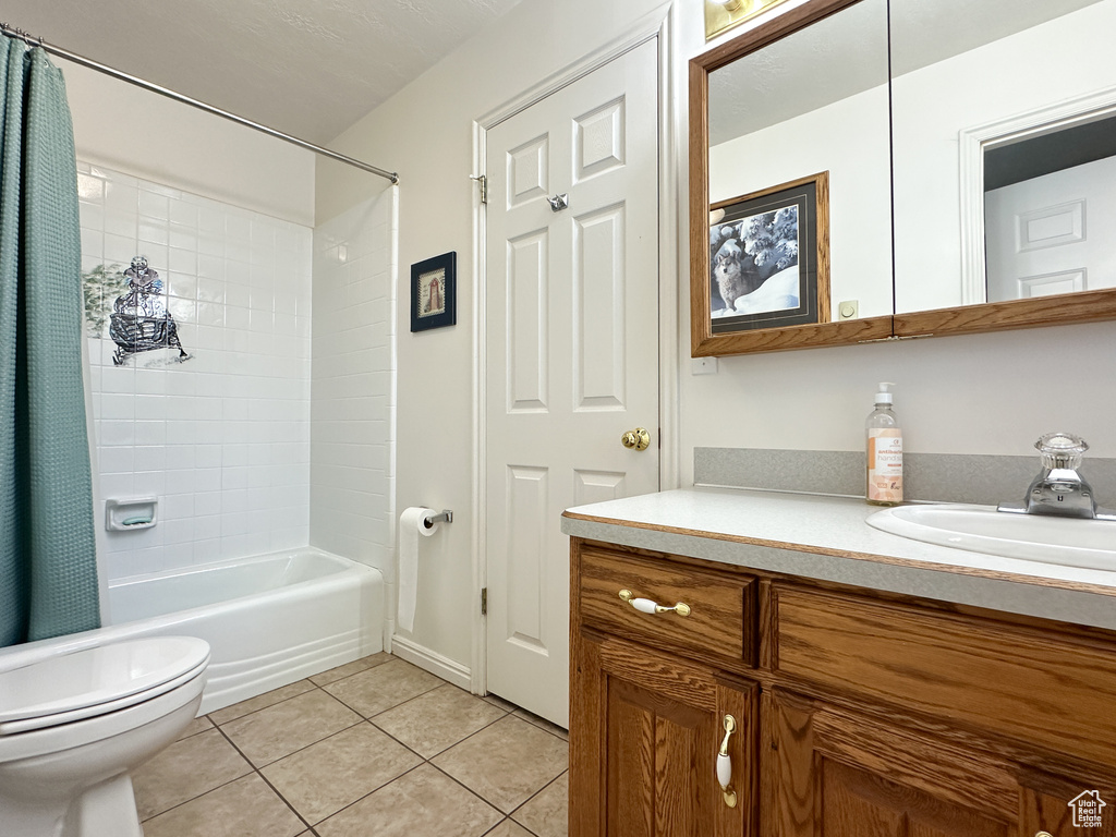 Full bathroom with vanity, tile patterned flooring, toilet, and shower / bath combination with curtain