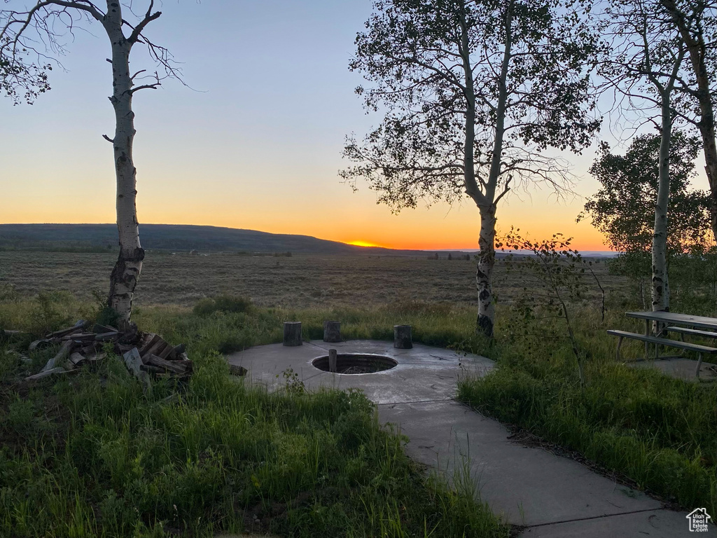 View of community with a rural view and an outdoor fire pit