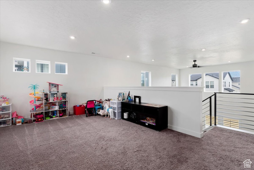 Game room featuring carpet, a textured ceiling, and ceiling fan