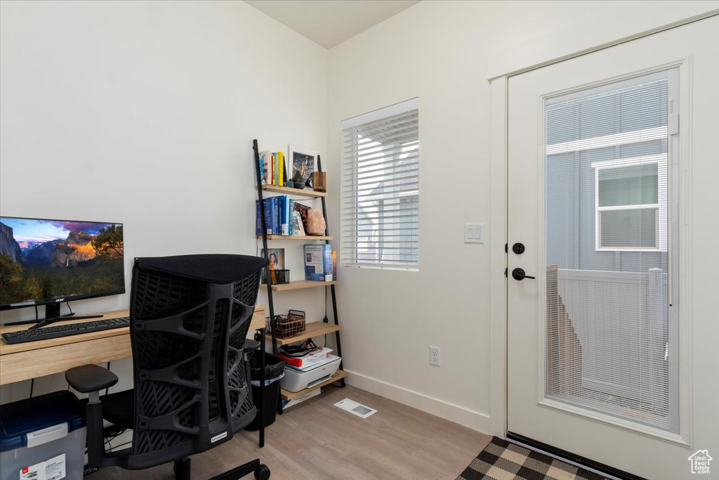 Office space featuring light wood-type flooring