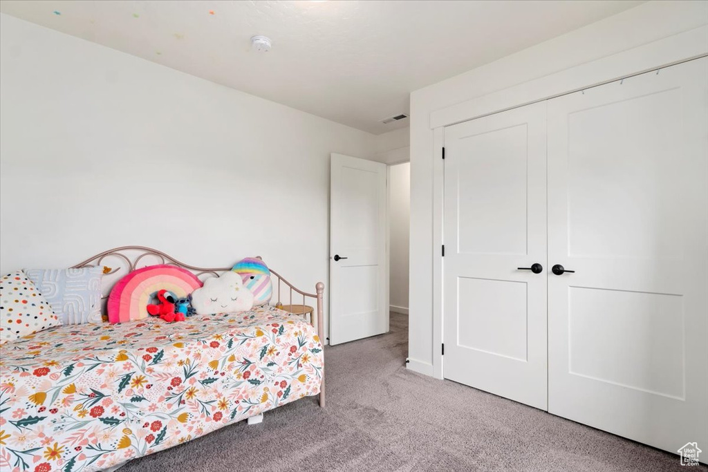 Bedroom featuring a closet and carpet flooring