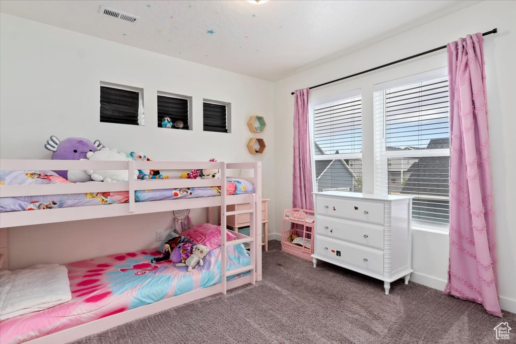 Bedroom featuring dark colored carpet