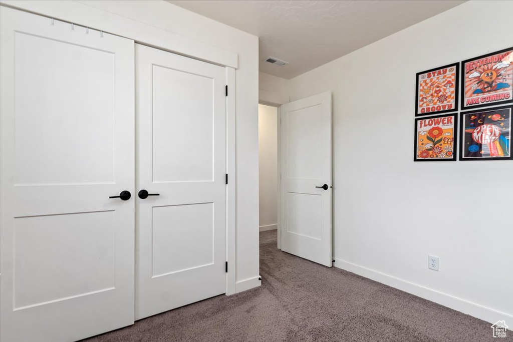 Unfurnished bedroom with a closet and carpet