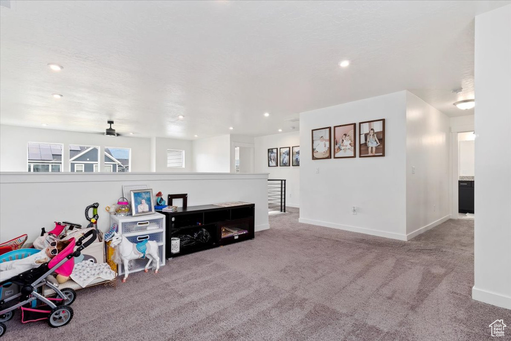 Playroom with carpet and ceiling fan