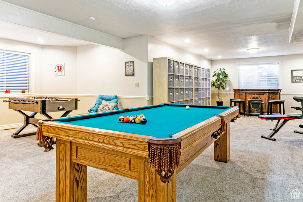 Playroom featuring bar area, billiards, carpet floors, and a textured ceiling