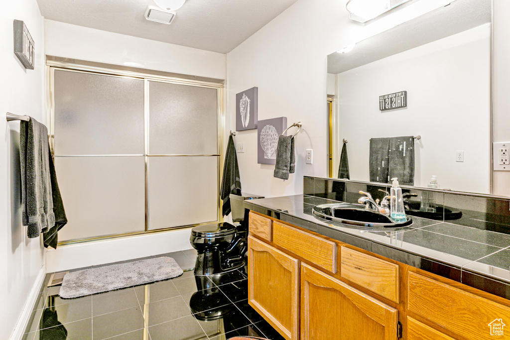 Bathroom with vanity and tile patterned flooring