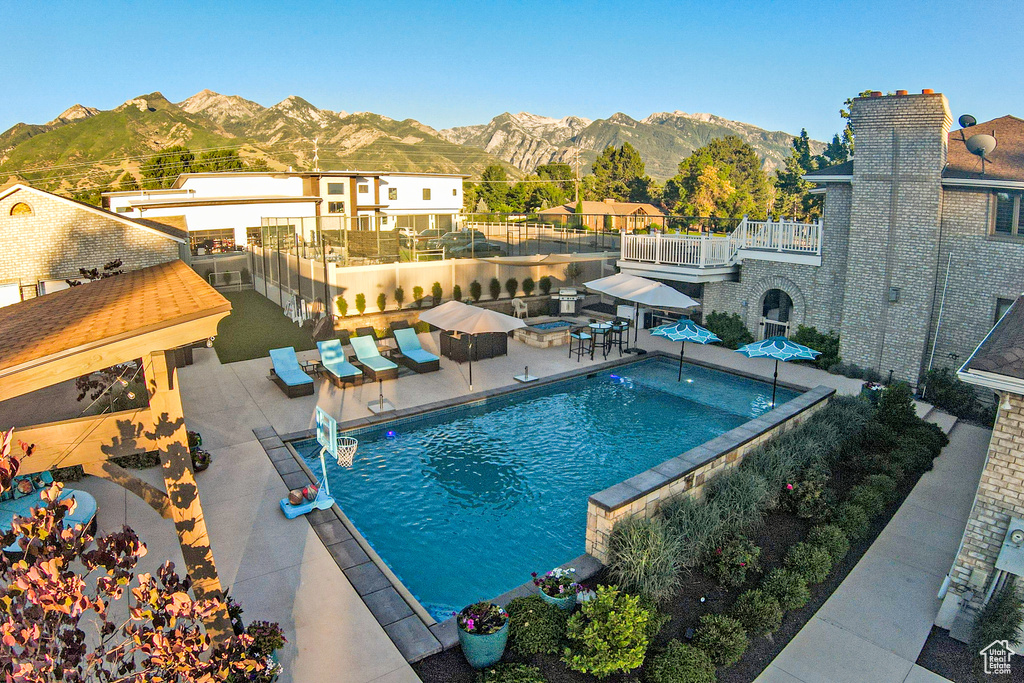 View of swimming pool featuring a patio and a mountain view