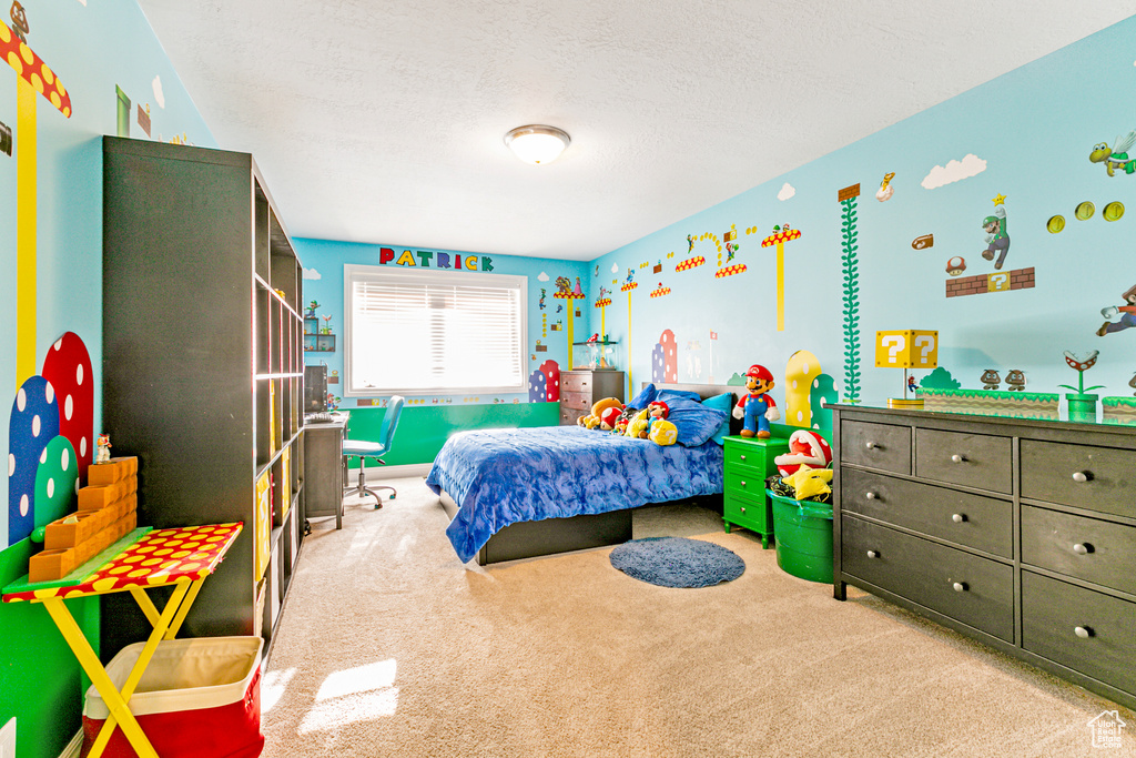 Bedroom featuring a textured ceiling and light colored carpet