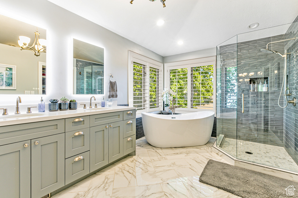 Bathroom with plus walk in shower, tile patterned flooring, a chandelier, and double sink vanity