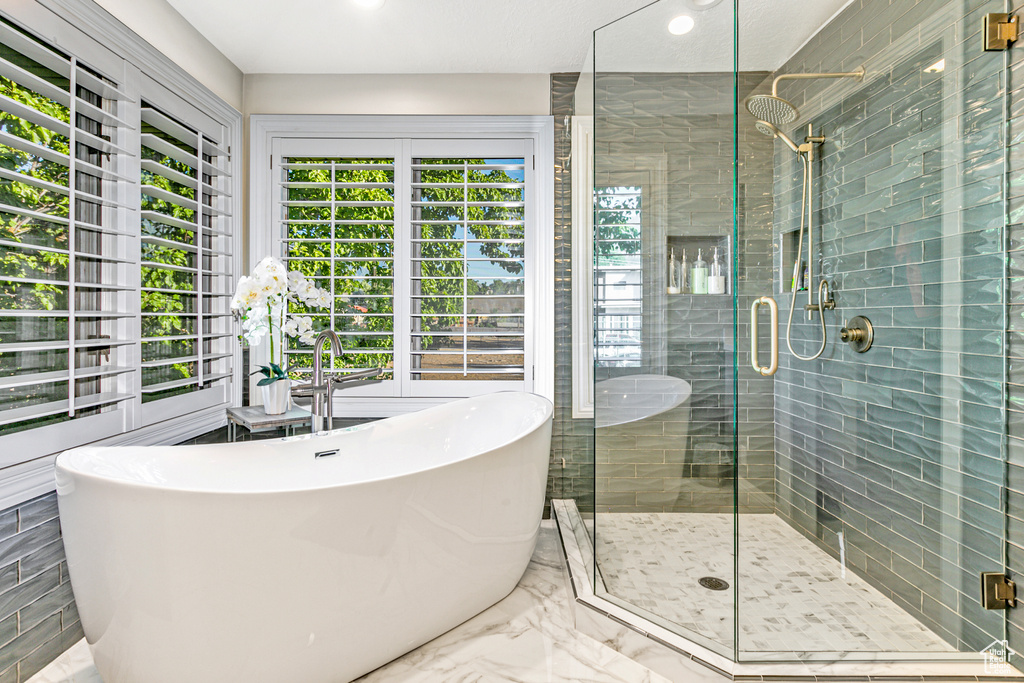 Bathroom with tile patterned flooring and plus walk in shower