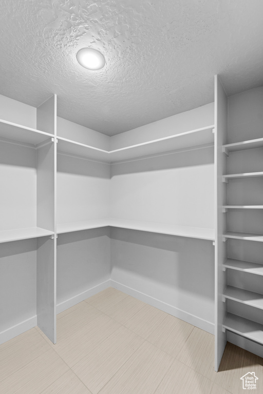 Walk in closet featuring tile patterned flooring