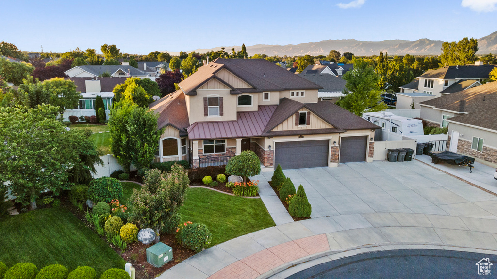 View of front of house with a garage and a mountain view