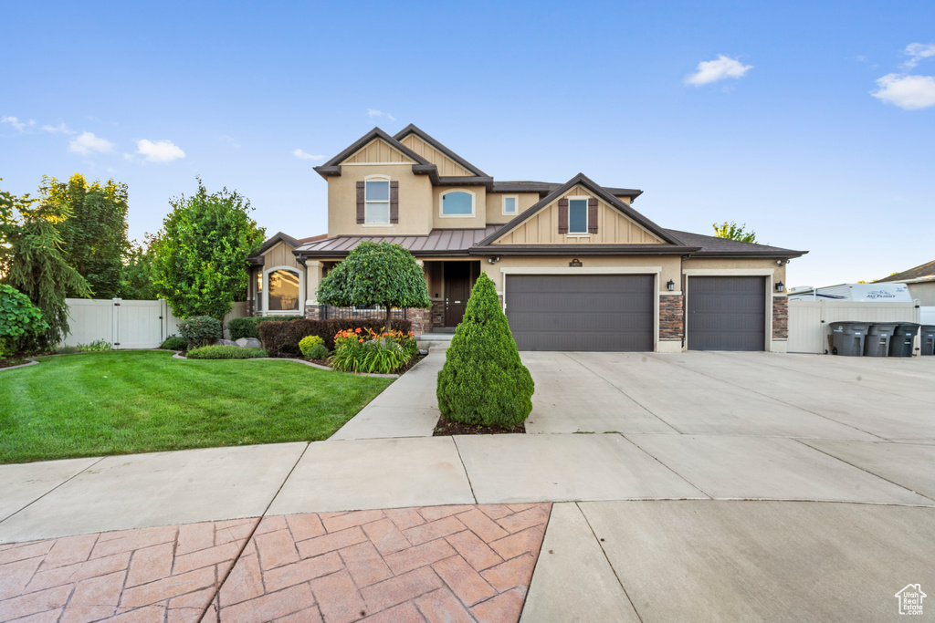 Craftsman-style house with a garage and a front yard