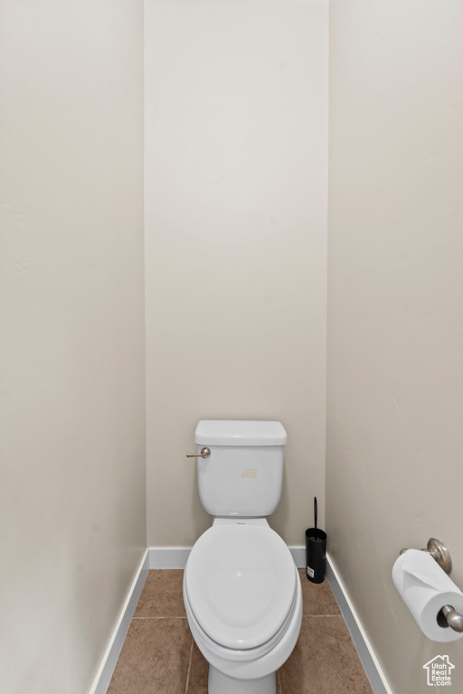 Bathroom featuring toilet and tile patterned flooring