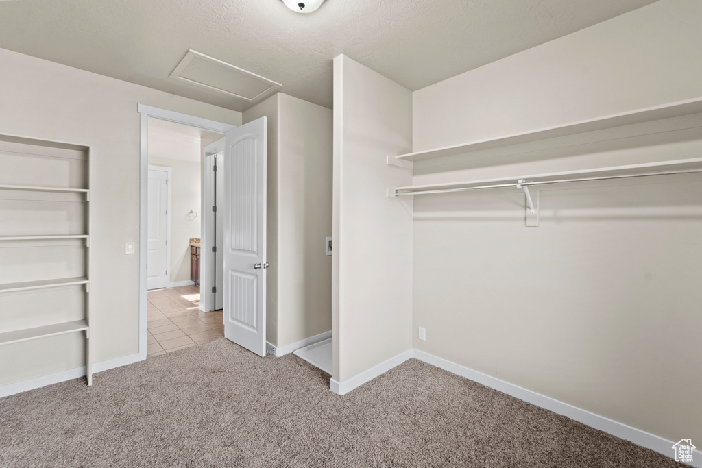 Spacious closet with light tile patterned flooring