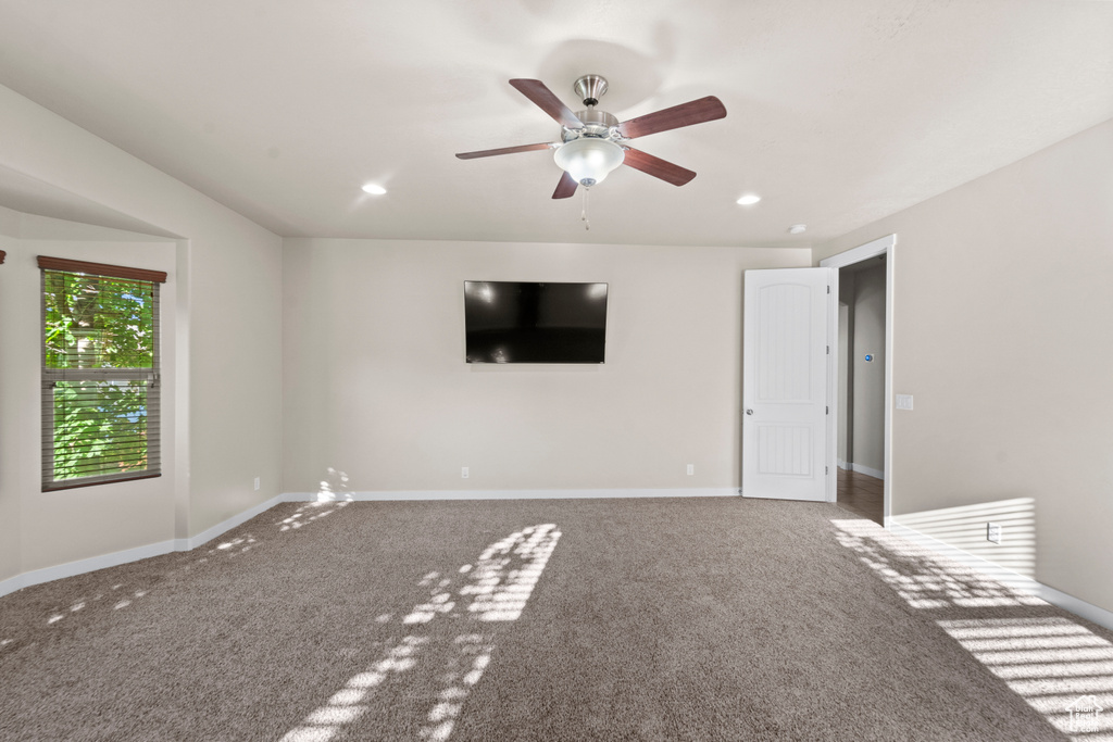 Unfurnished bedroom featuring carpet floors and ceiling fan