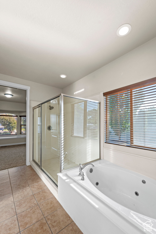 Bathroom featuring separate shower and tub and tile patterned flooring