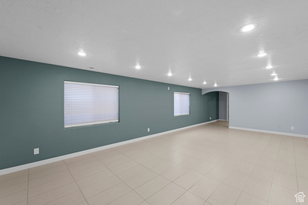 Empty room with light tile patterned flooring