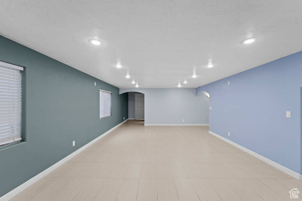 Empty room with light tile patterned floors