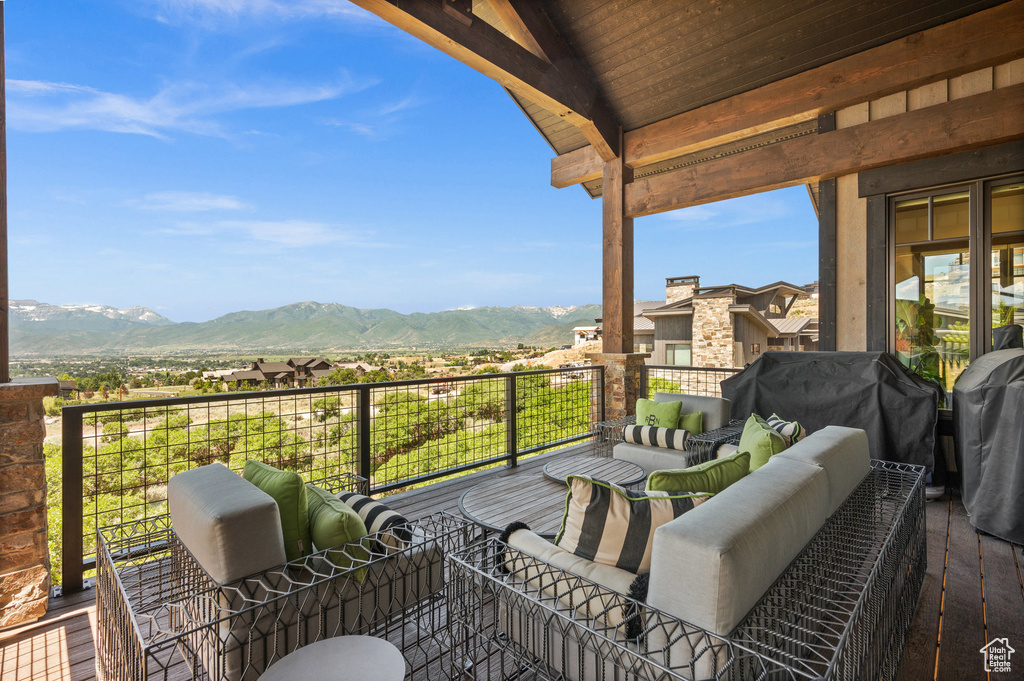 Balcony with area for grilling, a mountain view, and an outdoor hangout area