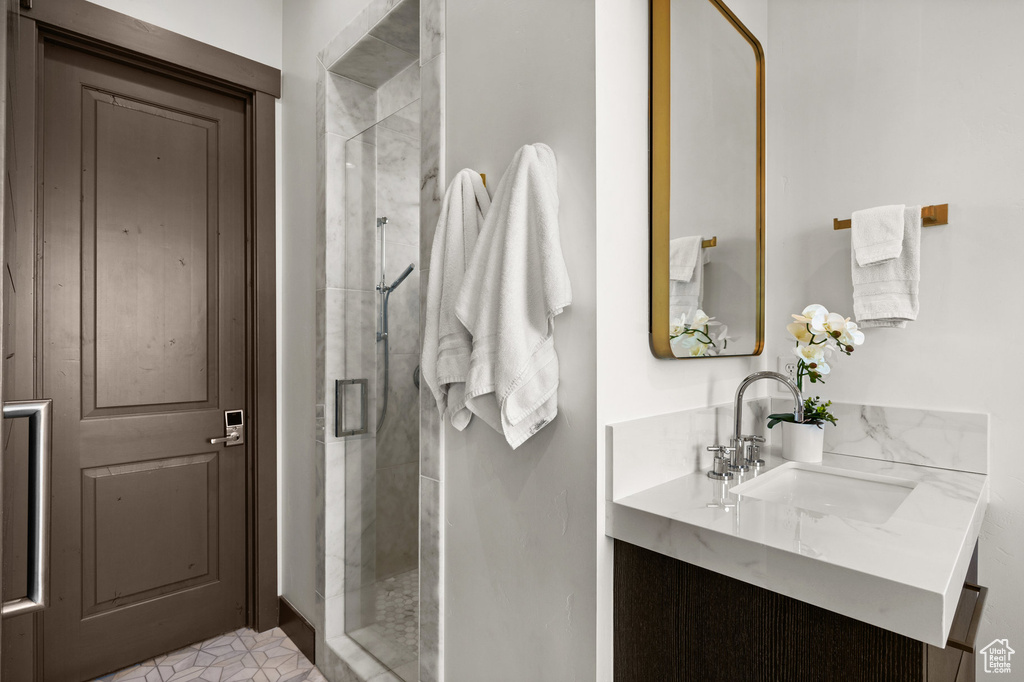 Bathroom with vanity and a shower with door