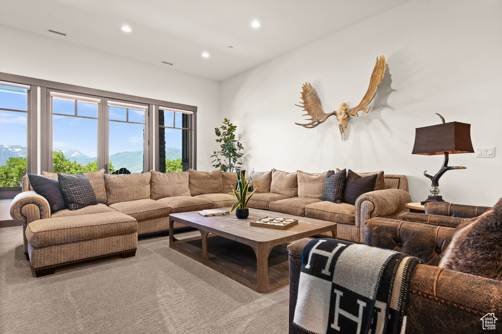 Living room featuring light carpet and a mountain view