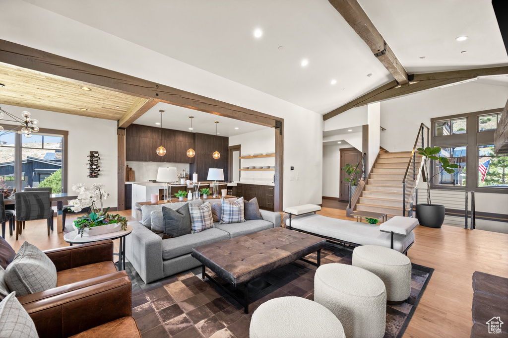 Living room featuring lofted ceiling with beams and hardwood / wood-style floors