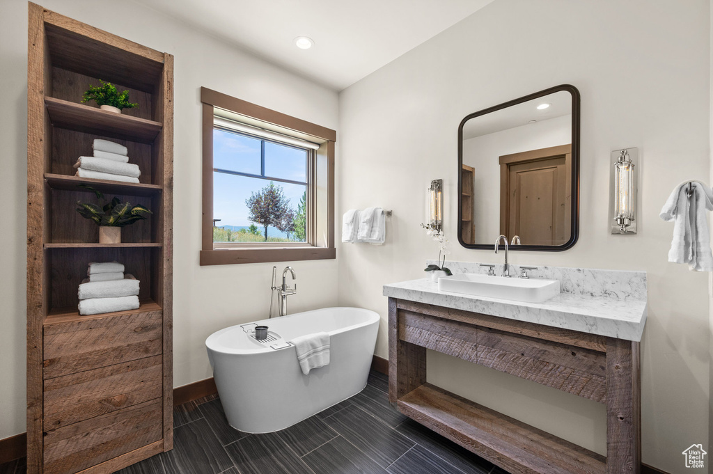 Bathroom with a tub and vanity