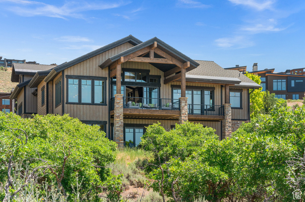 Back of property with a balcony