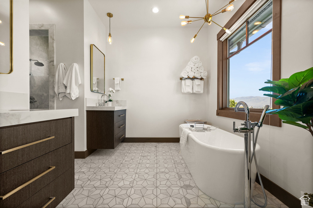 Bathroom featuring vanity and shower with separate bathtub