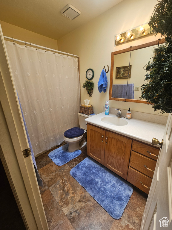 Bathroom with tile patterned flooring, toilet, and vanity