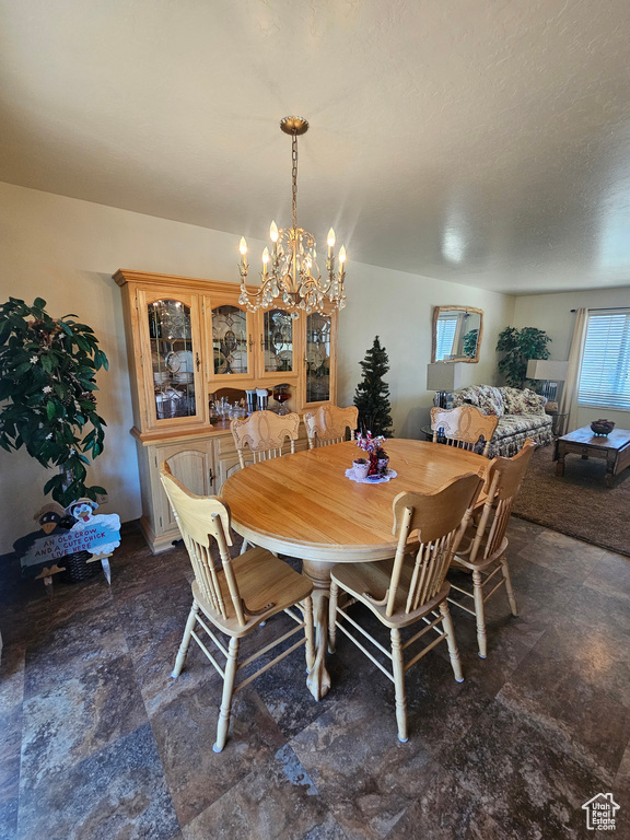 Tiled dining space featuring a notable chandelier