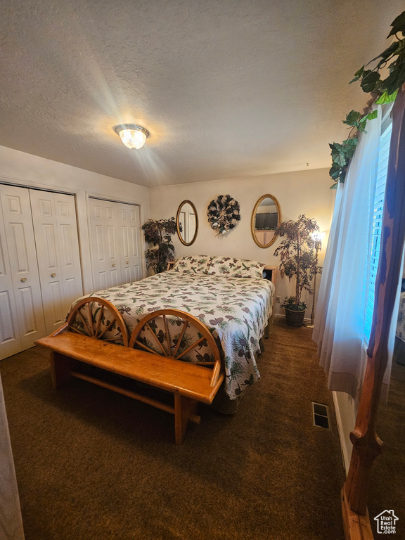 Carpeted bedroom with a textured ceiling