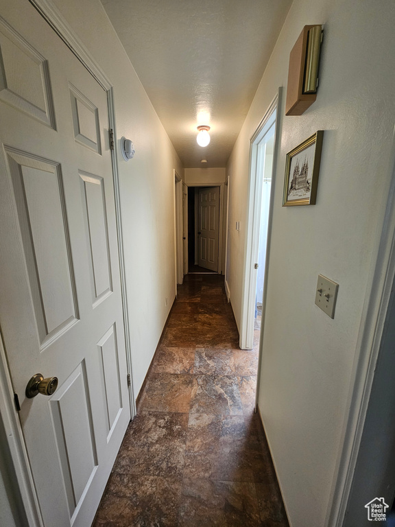 Hall with dark tile patterned flooring